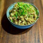 Bowl containing homemade egg fried rice. Topped with sliced spring onions.