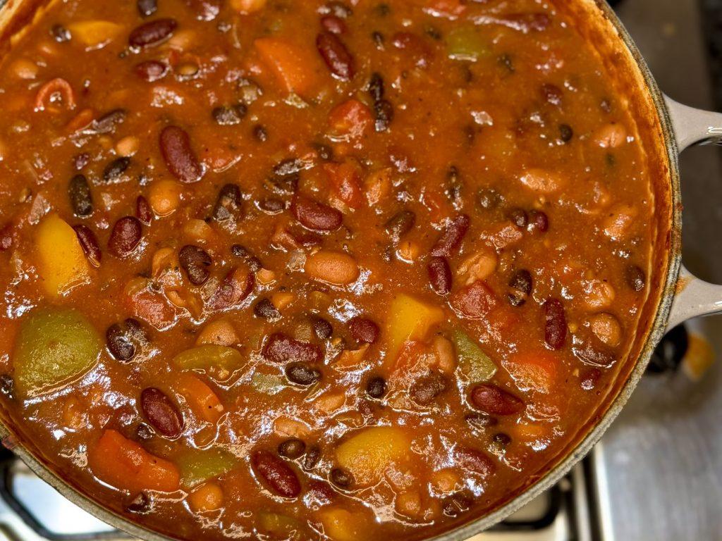 Pot of three bean chilli on the stove.