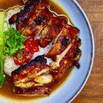 Bowl of gochujang chicken, rice, gochujang broth and pak choi