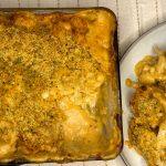 Spiced cauliflower cheese with a herby crumb spooned onto a plate