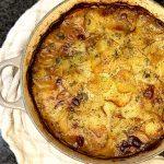 A freshly baked pot of lancashire hotpot, sitting on a towel.