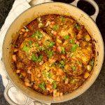 Pan of mexican chicken and rice on a counter with a towel