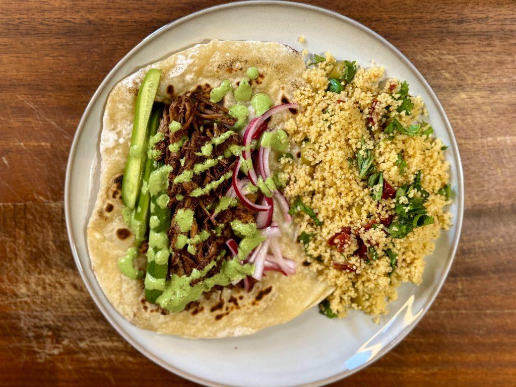 Slow cooked shawarma lamb leg on homemade lflat breads with couscous